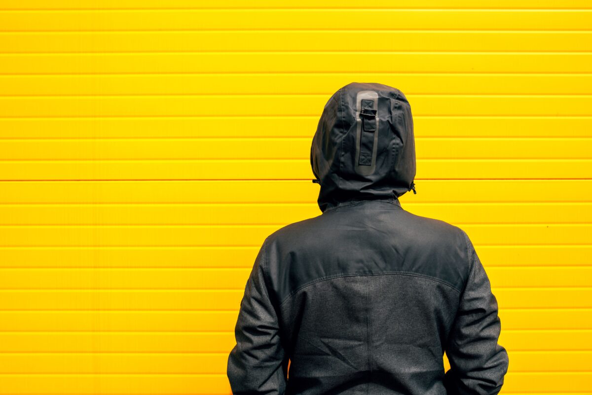 Person staring at a brick wall